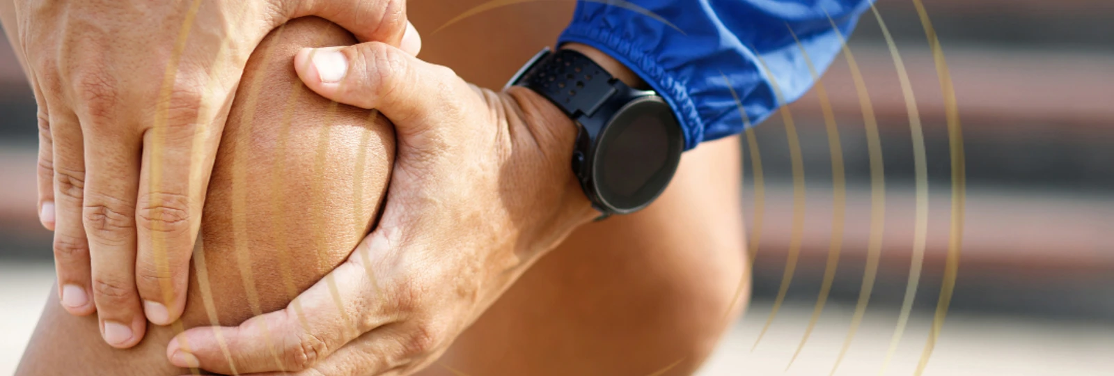 Close up of man in running gear holding knee in pain.