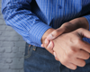 Man in blue wrist pain
