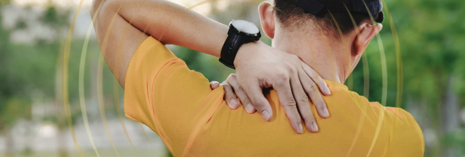 man wearing orange shirt with back pain.