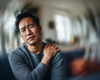 Man sad with shoulder pain.