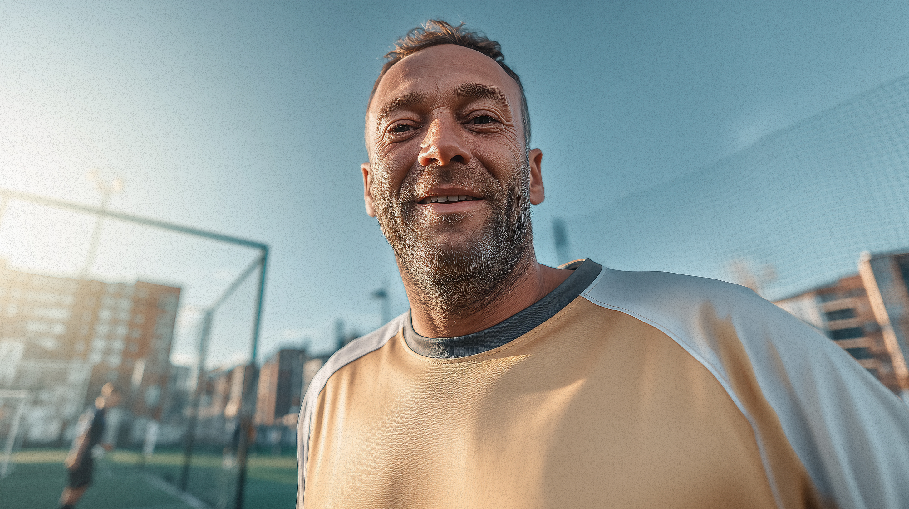 A man outside smiling.