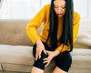 woman pressing knee in pain