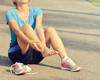woman holding foot in pain